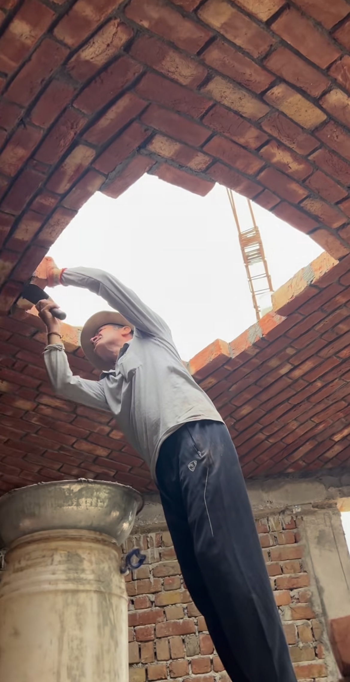 Worker finishing herringbone brick vault ceiling - Rohtak Domes 2025