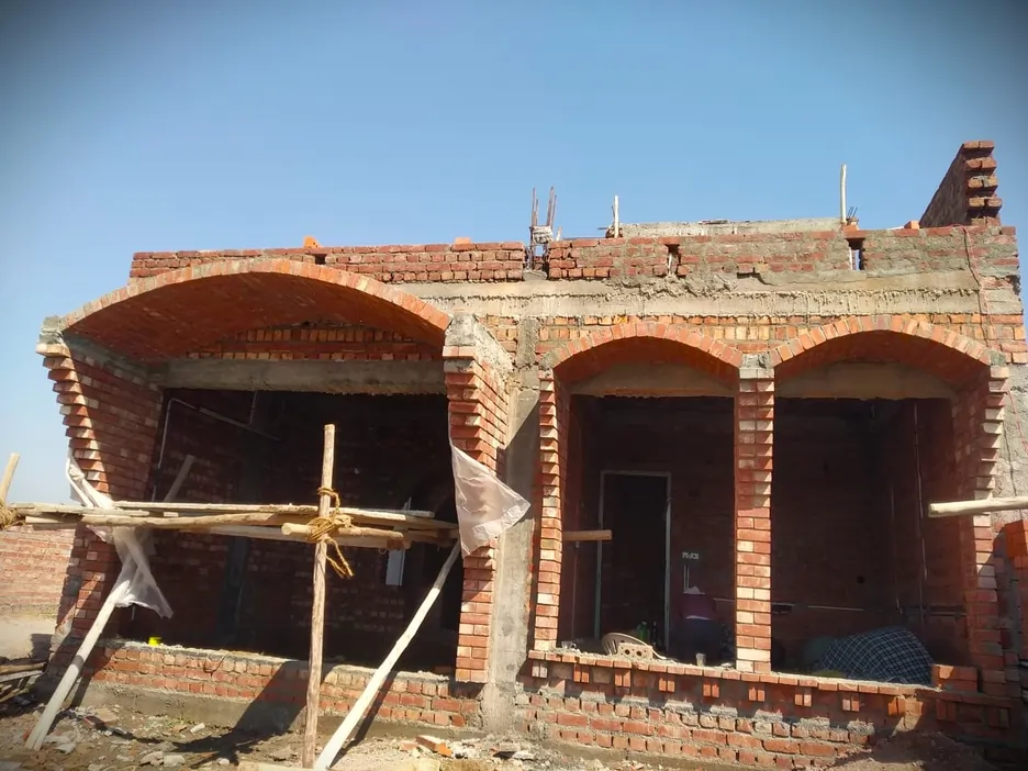 Building under construction with brick arches by Rohtak Domes